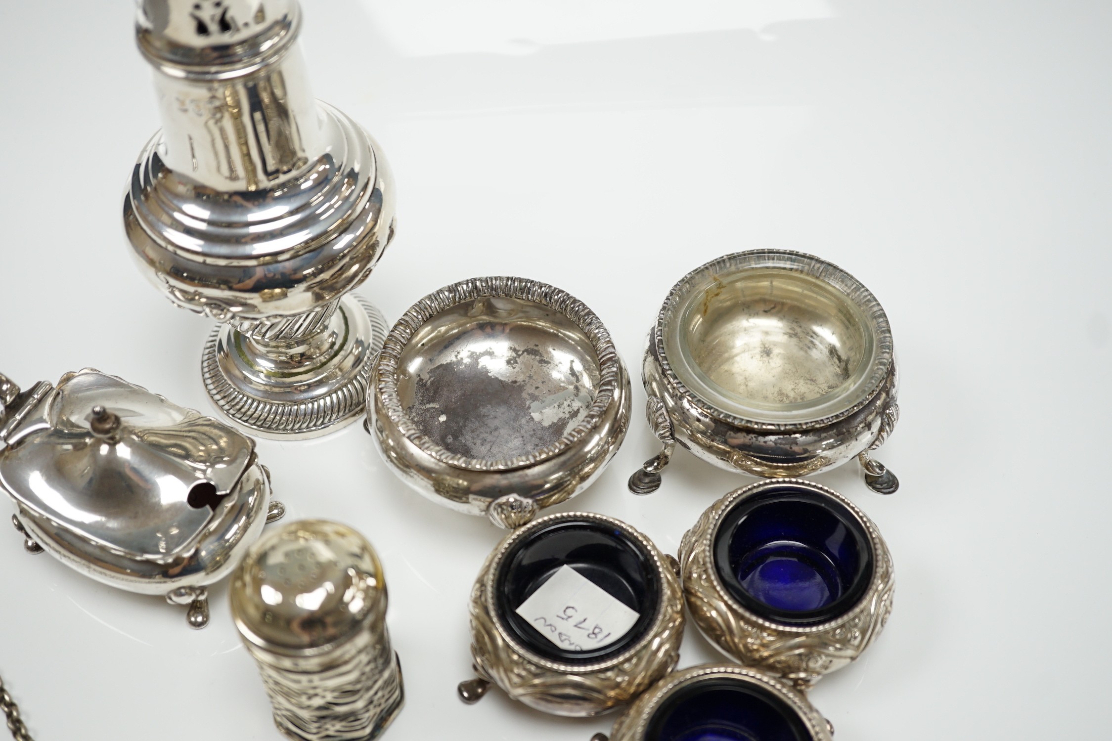 A mixed group of assorted small silver including a sugar caster, two pairs of Victorian bun salts, mustard pot, salt, pepperette, spoon and four white metal spoons.